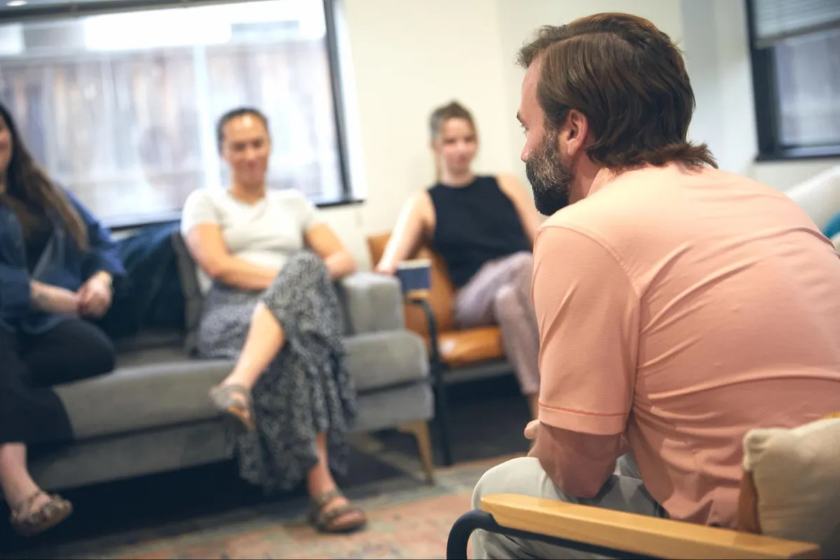 A therapist leading a group therapy session at a residential treatment center in Texas